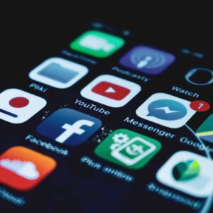 Detailed close-up view of a smartphone screen displaying various popular social media app icons.